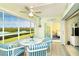 Bright sunroom with water views and table for four at 2424 Placida Rd # C101, Englewood, FL 34224