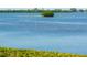 Stunning view of calm water, lush greenery, and a small island at 2424 Placida Rd # C101, Englewood, FL 34224