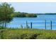 Serene waterfront view with lush vegetation and calm water at 2424 Placida Rd # C101, Englewood, FL 34224