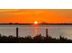 Stunning sunset over calm water with distant cityscape at 2424 Placida Rd # C101, Englewood, FL 34224