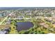 Aerial view of house near lake in residential neighborhood at 252 Medalist Rd, Rotonda West, FL 33947