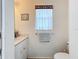 Small bathroom with toilet, sink, and shower at 252 Medalist Rd, Rotonda West, FL 33947