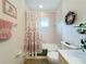 Charming bathroom with seashell-themed decor and a shower/tub combo at 252 Medalist Rd, Rotonda West, FL 33947