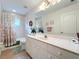 Bathroom boasts a vanity with marble countertop and a shower/tub combo at 252 Medalist Rd, Rotonda West, FL 33947