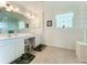 Double vanity bathroom with a large mirror and separate shower and toilet at 252 Medalist Rd, Rotonda West, FL 33947