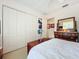 Bright bedroom with a queen bed, built-in dresser, and ample closet space at 252 Medalist Rd, Rotonda West, FL 33947