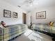 Spacious bedroom with two twin beds, ample closet space, and a ceiling fan at 252 Medalist Rd, Rotonda West, FL 33947