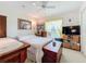 Bedroom with a queen bed, large TV, and built-in shelving at 252 Medalist Rd, Rotonda West, FL 33947