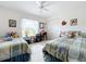 Bedroom with two twin beds, a window seat, and plenty of natural light at 252 Medalist Rd, Rotonda West, FL 33947