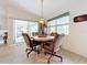 Casual dining area with view of screened porch and kitchen at 252 Medalist Rd, Rotonda West, FL 33947
