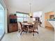 Bright dining area with table and chairs, adjacent to kitchen and pool view at 252 Medalist Rd, Rotonda West, FL 33947