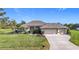 Single-story house with a two-car garage and well-maintained lawn at 252 Medalist Rd, Rotonda West, FL 33947
