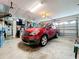 Garage with car and overhead storage at 252 Medalist Rd, Rotonda West, FL 33947