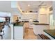 Open kitchen with island, white appliances, and green counters at 252 Medalist Rd, Rotonda West, FL 33947