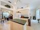 Open kitchen with island, white appliances & green countertops at 252 Medalist Rd, Rotonda West, FL 33947