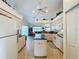 Open kitchen with island, white appliances & green countertops at 252 Medalist Rd, Rotonda West, FL 33947