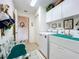 Bright laundry room with washer, dryer and bench at 252 Medalist Rd, Rotonda West, FL 33947
