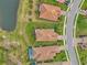 Aerial view of homes, streets, and a pond in a residential community at 26906 Weiskopf Dr, Englewood, FL 34223