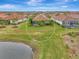 Aerial view showcasing a home's backyard and surrounding landscape at 26906 Weiskopf Dr, Englewood, FL 34223