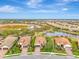 Aerial view of a tan house in a residential neighborhood at 26906 Weiskopf Dr, Englewood, FL 34223