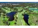 Aerial view of golf course with water features at 26906 Weiskopf Dr, Englewood, FL 34223