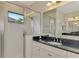 Bathroom with walk-in shower and double vanity at 26906 Weiskopf Dr, Englewood, FL 34223