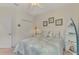 Bedroom with light blue bedding, white nightstand and built-in shelving at 26906 Weiskopf Dr, Englewood, FL 34223