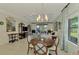 Charming dining room with wooden table and chairs, near kitchen at 26906 Weiskopf Dr, Englewood, FL 34223
