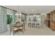 Bright dining area with wooden table and chairs, near kitchen at 26906 Weiskopf Dr, Englewood, FL 34223