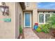 Teal front door with brick walkway and landscaping at 26906 Weiskopf Dr, Englewood, FL 34223