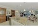 Open kitchen, granite island, wine fridge, stainless steel appliances at 26906 Weiskopf Dr, Englewood, FL 34223