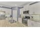 Modern kitchen featuring stainless steel appliances and granite countertops at 26906 Weiskopf Dr, Englewood, FL 34223