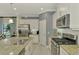 Bright kitchen with stainless steel appliances and granite countertops at 26906 Weiskopf Dr, Englewood, FL 34223