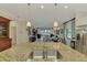 Open kitchen with granite island overlooking living area at 26906 Weiskopf Dr, Englewood, FL 34223