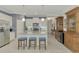 Modern kitchen with granite island and white cabinets at 26906 Weiskopf Dr, Englewood, FL 34223