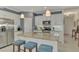 Modern kitchen with granite island, white cabinets, and blue stools at 26906 Weiskopf Dr, Englewood, FL 34223