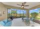 Screened lanai with outdoor furniture and golf course views at 26906 Weiskopf Dr, Englewood, FL 34223