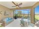Screened lanai with outdoor furniture and golf course views at 26906 Weiskopf Dr, Englewood, FL 34223