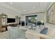 Spacious living room with comfy seating and large TV at 26906 Weiskopf Dr, Englewood, FL 34223