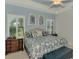 Main bedroom with king-size bed and stylish decor at 26906 Weiskopf Dr, Englewood, FL 34223