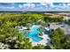 Aerial view of community pool with multiple pools and a clubhouse at 26906 Weiskopf Dr, Englewood, FL 34223