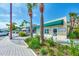 Picturesque storefront with green awning and lush landscaping at 26906 Weiskopf Dr, Englewood, FL 34223