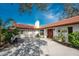 View of the house from another angle, highlighting the red door at 307 Gladstone Blvd, Englewood, FL 34223