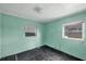 Small bedroom with light teal walls, needs renovation at 321 S Mango St, Englewood, FL 34223