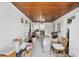 Enclosed porch with wood ceiling and access to backyard at 321 S Mango St, Englewood, FL 34223