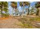 Quaint single-story home surrounded by palm trees at 321 S Mango St, Englewood, FL 34223