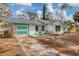 Single-story house with attached garage, needs some TLC at 321 S Mango St, Englewood, FL 34223