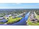 Aerial view of a waterfront community with private canals and docks on a sunny day at 3522 Fox Ter, Port Charlotte, FL 33981