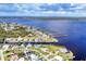 Waterfront homes with private docks and sea walls on an estuary in an aerial view at 3522 Fox Ter, Port Charlotte, FL 33981