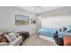 Well-lit bedroom with a single bed, comfortable armchair, and a view from the window at 3522 Fox Ter, Port Charlotte, FL 33981
